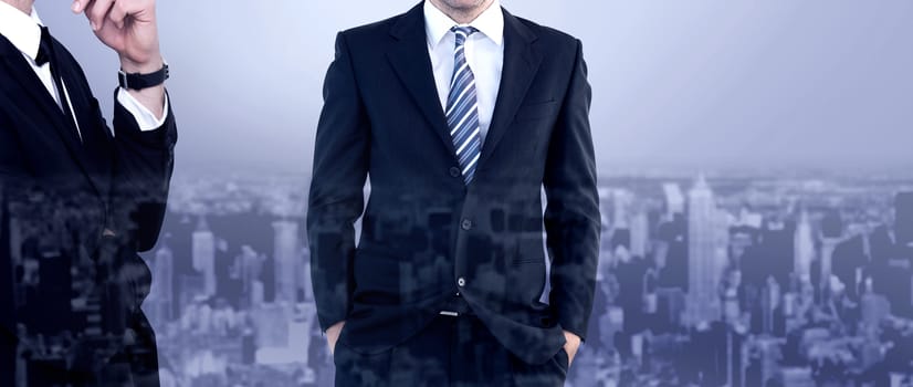 Smiling businessman standing with hands in pockets against high angle view of city