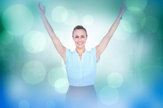 Businesswoman with arms raised against green abstract light spot design