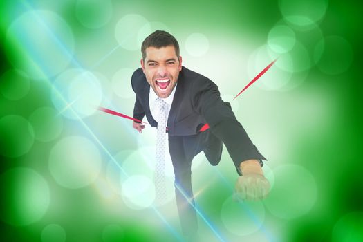 Businessman crossing the finish line against green abstract light spot design