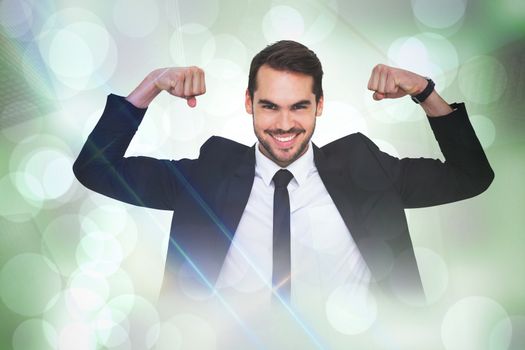 Happy businessman in suit cheering  against grey abstract light spot design