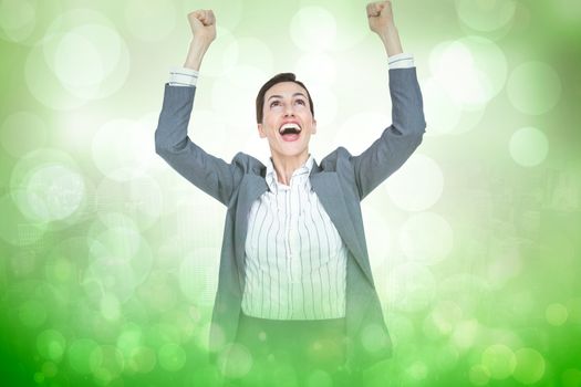 Cheering businesswoman against green abstract light spot design