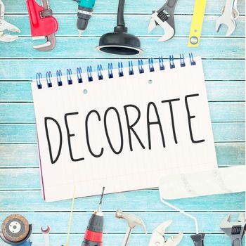 The word decorate  against tools and notepad on wooden background