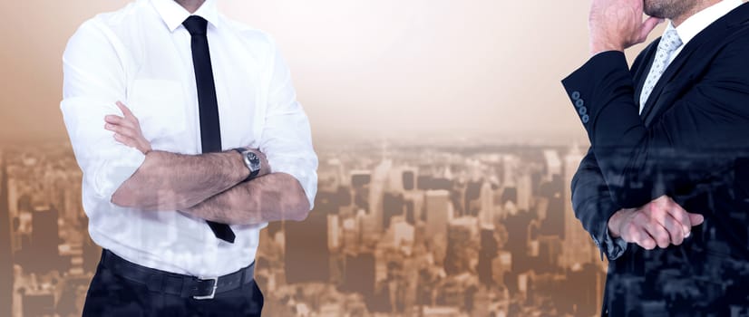 Smiling businessman with arms crossed against high angle view of city