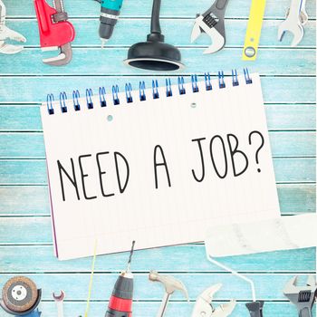 The word need a job? against tools and notepad on wooden background