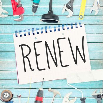 The word renew against tools and notepad on wooden background