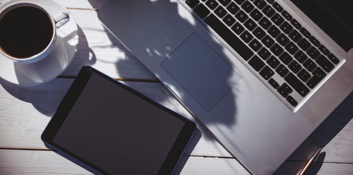 Overhead shot of laptop and tablet on a desk