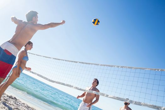 Friends playing volleyball at the beach