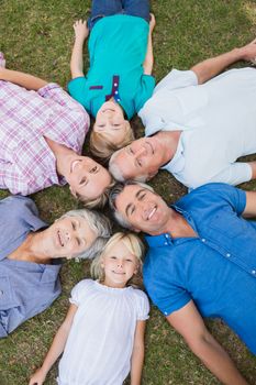 Happy family looking up the camera on a sunny day