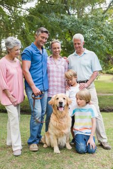 Happy family in the park with their dog on a sunny day