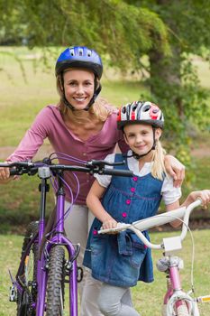 Mother and her daughter on their bike on a sunny day