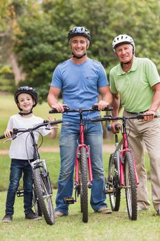 Happy multi generation family on their bike at the park on a sunny day 