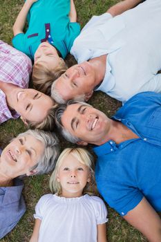 Happy family looking up the camera on a sunny day