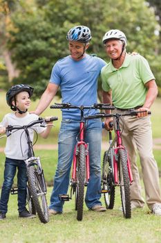 Happy multi generation family on their bike at the park on a sunny day 