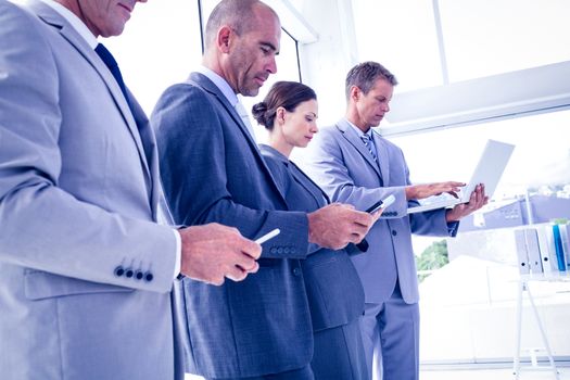 Business team using their media devices in the office