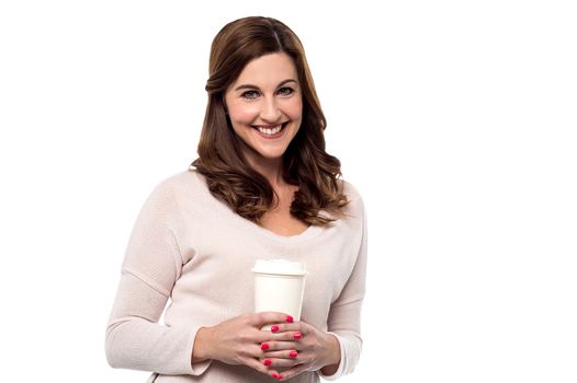 Smiling woman posing with disposable cup