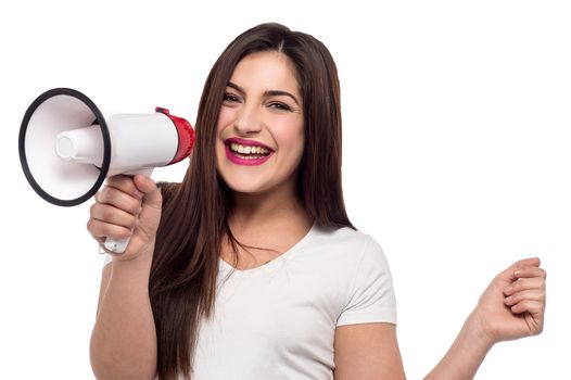 Cheerful woman proclaiming over megaphone