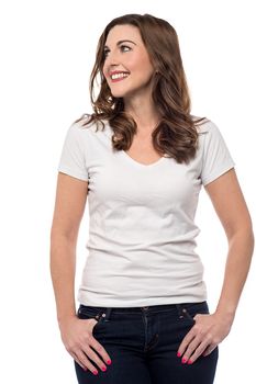 Happy woman standing with hands in pockets