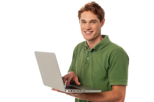 Young man posing with his laptop
