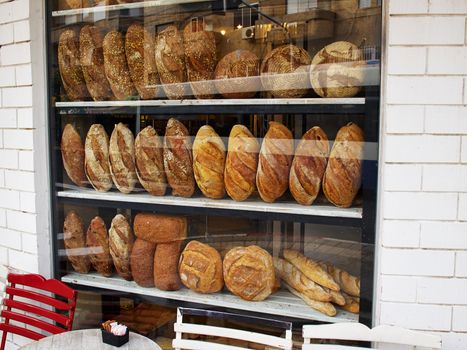 Assortment of baked bread in a bakery window display  