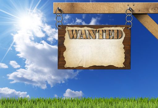 Dark wooden sign with torn empty parchment with text Wanted. Hanging from a metal chain on a wooden pole on blue sky with clouds and sun rays