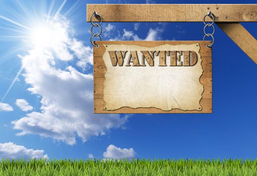 Wooden sign with planks and torn empty parchment with text Wanted. Hanging from a metal chain on a wooden pole on blue sky with clouds and sun rays