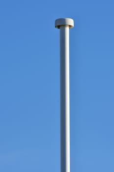 Empty lampost with blue sky in background