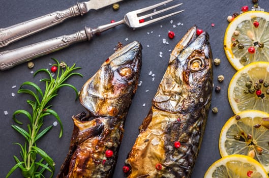 Baked Whole Mackerel Fish with Spice, Lemon and Rosemary on Grey Stone