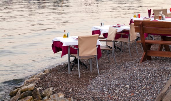   some little tables of the restaurant, standing near a bay. Montenegro