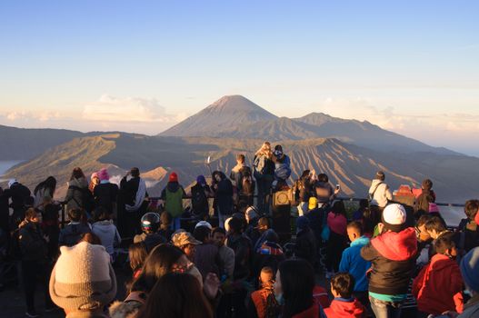 Tourists watching sunrise over Bromo volcano, Tengger Semeru National Park, East Java, Indonesia on June 26, 2014