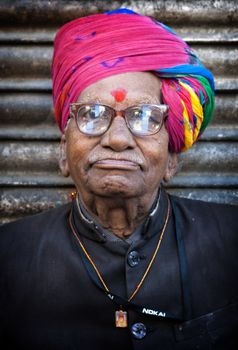 Indian man in colourful turban posing in Jodhpur, India. February 27, 2013