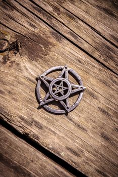 Old steel Pentagram closeup photo on background