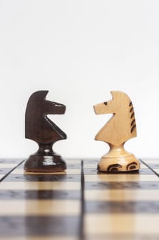 Chess pieces facing each other to symbolize a challenge