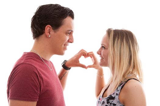 Young couple in lovemaking heart with hands over white background