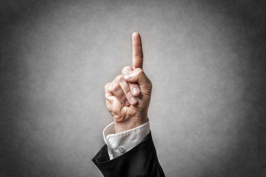 Closeup hand with gesture and arm of a businessman in dark suit