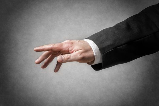 Closeup hand with gesture and arm of a businessman in dark suit