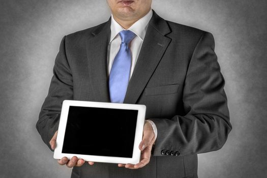 Businessman in dark suit with a tablet computer and blank space