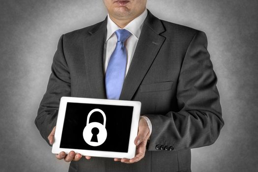 Businessman in dark suit with a tablet computer that shows a padlock