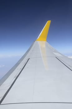 Wing of airplane flying in the sky