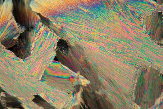 Crystals of acetylsalicylic acid under a microscope. The crystals are precipitated from a solution on a microscope slide and photographed in polarized light.