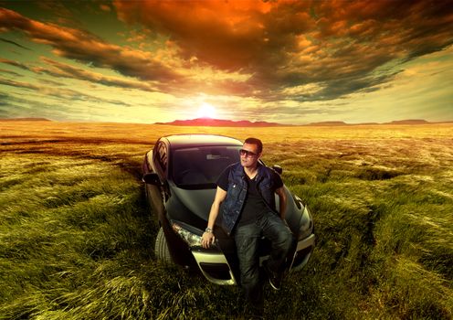 Dreamy fields sunset landscape and fashion man with a car