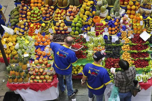 SAO PAULO/BRAZIL - MAY 9: An unidentified vendor at a fruit stand in Central Market of Sao Paulo on May 09, 2015. This landmark is a destination for tourists and locals.