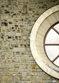 the circular window on a stone wall