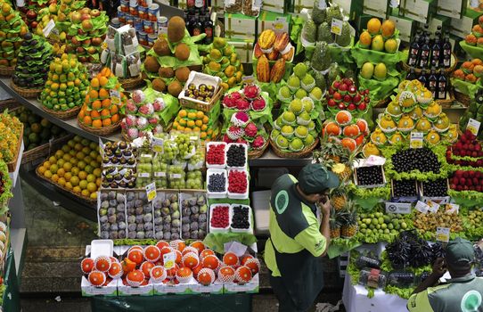 SAO PAULO/BRAZIL - MAY 9: An unidentified vendor at a fruit stand in Central Market of Sao Paulo on May 09, 2015. This landmark is a destination for tourists and locals.