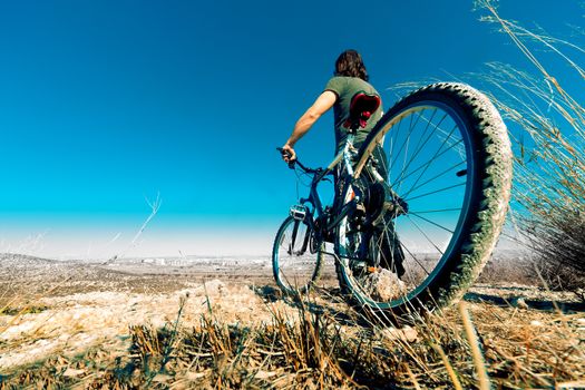 Landscape and young man with mountain bike.Lifestyle and sport