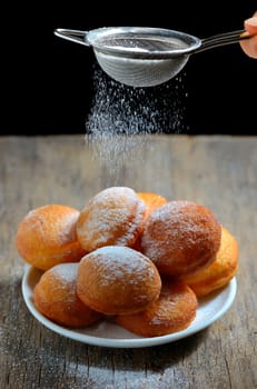 Donuts with powdered sugar on table