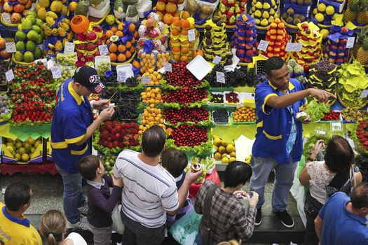 SAO PAULO/BRAZIL - MAY 9: An unidentified vendor at a fruit stand in Central Market of Sao Paulo on May 09, 2015. This landmark is a destination for tourists and locals.