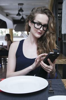 cute model in glasses chat on smartphone
