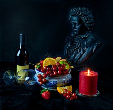 Still life with fruit and a glass of wine candle and beethoven