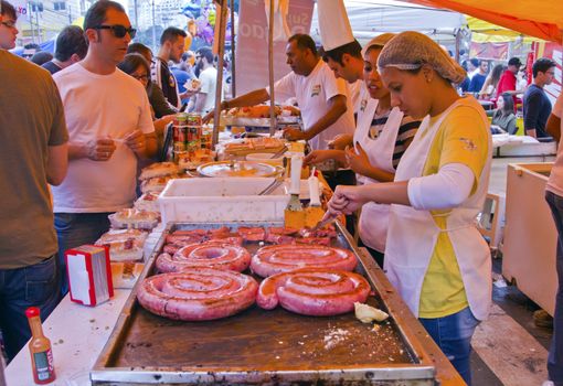 SAO PAULO, BRAZIL - MAY 17, 2015: An unidentified group of people in the hand made sausage sandwich stand in street fair market in Sao Paulo. 