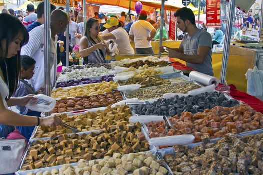 SAO PAULO, BRAZIL - MAY 17, 2015: An unidentified group of people in the hand made sweet stand at a street fair market in Sao Paulo. 